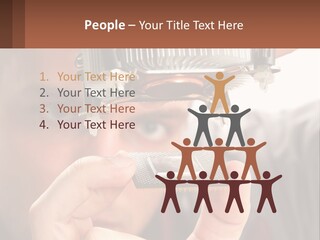 A Man Holding Up A Piece Of Metal In Front Of His Face PowerPoint Template