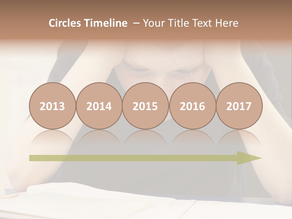 A Young Boy Sitting At A Desk With His Hands On His Head PowerPoint Template