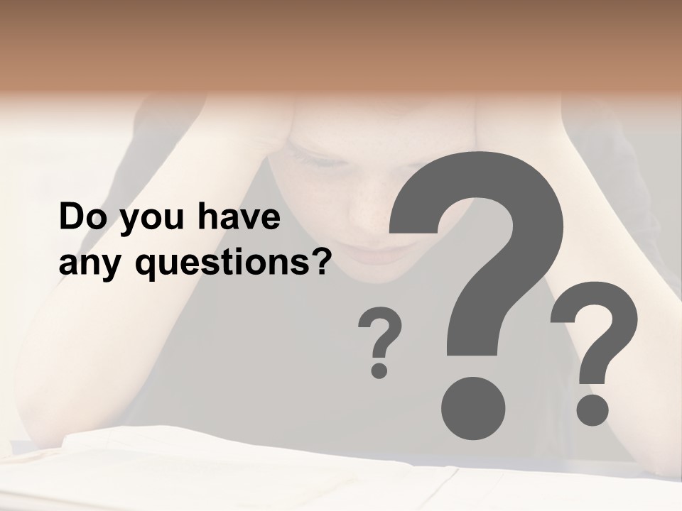 A Young Boy Sitting At A Desk With His Hands On His Head PowerPoint Template