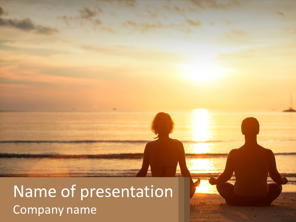 Two People Are Sitting On The Beach At Sunset PowerPoint Template