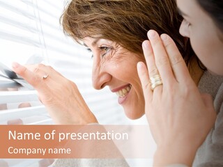 A Woman Looking Out A Window With A Smile On Her Face PowerPoint Template