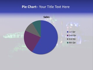 A Power Plant Lit Up At Night With Green And Blue Lights PowerPoint Template
