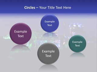 A Power Plant Lit Up At Night With Green And Blue Lights PowerPoint Template