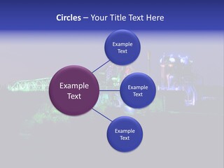A Power Plant Lit Up At Night With Green And Blue Lights PowerPoint Template