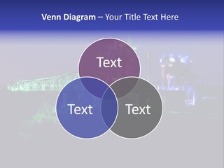 A Power Plant Lit Up At Night With Green And Blue Lights PowerPoint Template