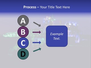 A Power Plant Lit Up At Night With Green And Blue Lights PowerPoint Template