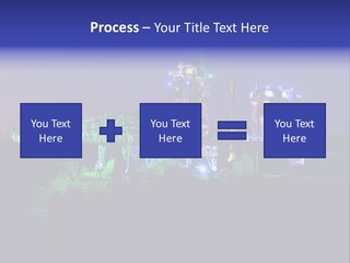 A Power Plant Lit Up At Night With Green And Blue Lights PowerPoint Template