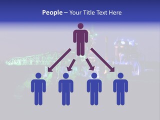 A Power Plant Lit Up At Night With Green And Blue Lights PowerPoint Template