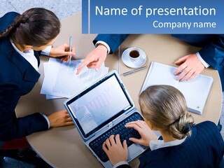 A Group Of People Sitting At A Table Working On Laptops PowerPoint Template
