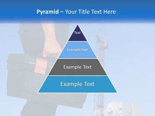 A Construction Worker Holding A Tool Box In Front Of A Crane PowerPoint Template