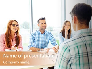 A Group Of People Sitting Around A Table PowerPoint Template