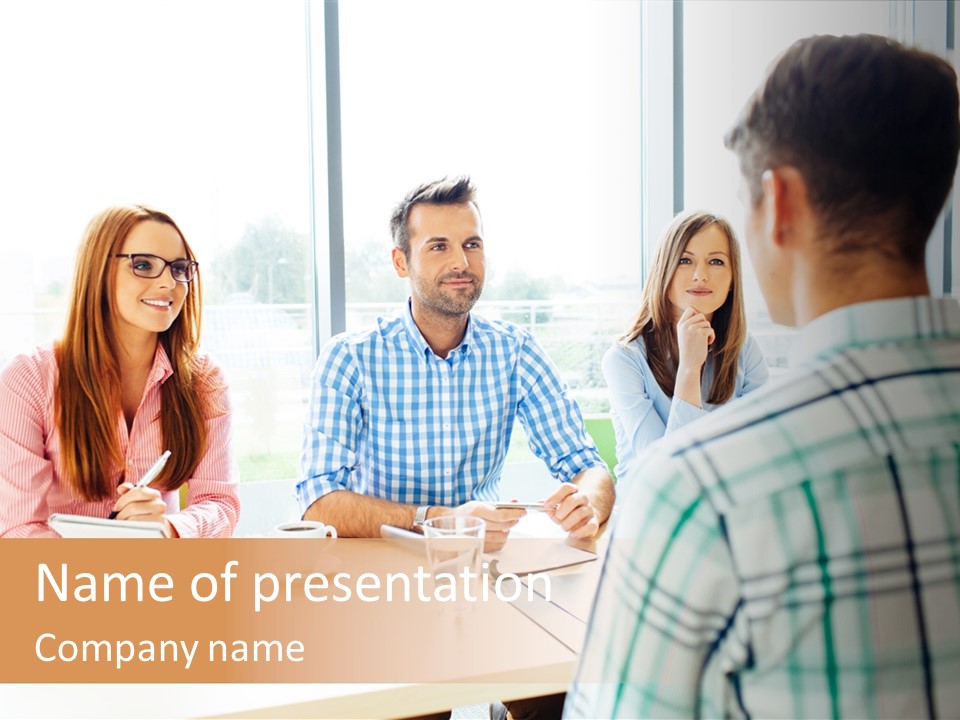 A Group Of People Sitting Around A Table PowerPoint Template