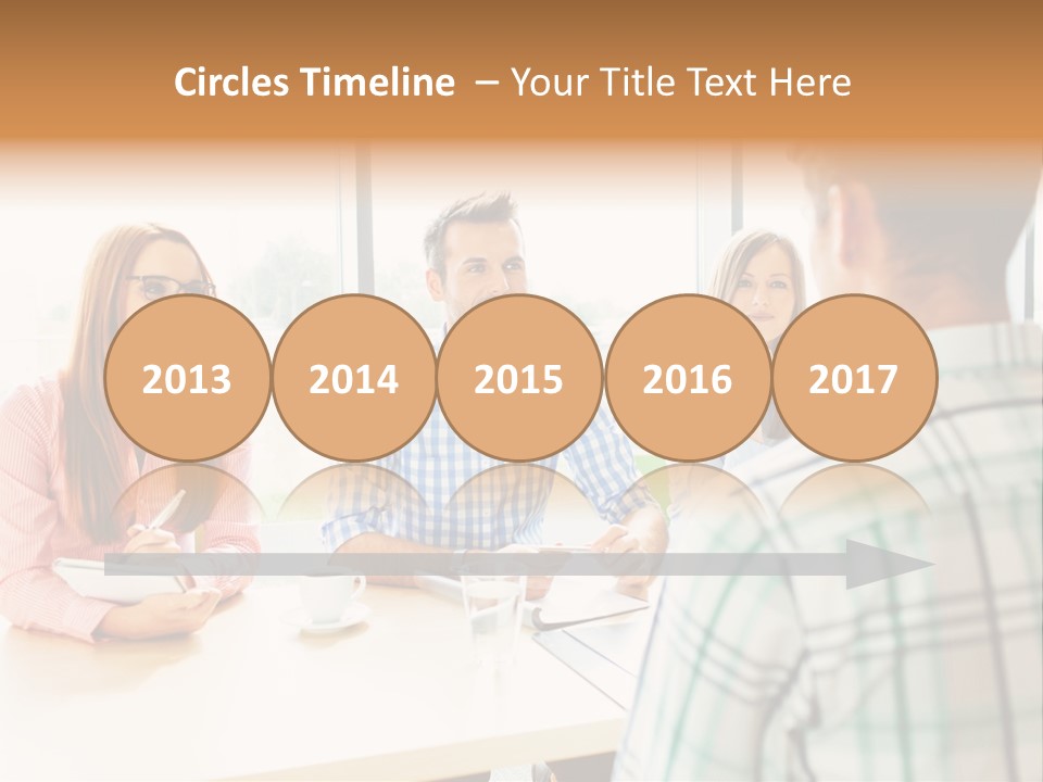 A Group Of People Sitting Around A Table PowerPoint Template