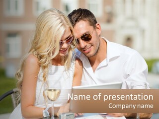 A Man And Woman Sitting At A Table With A Tablet PowerPoint Template