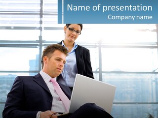 A Man And A Woman Are Looking At A Laptop PowerPoint Template