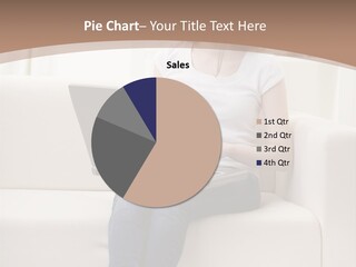 A Woman Sitting On A Couch Using A Laptop Computer PowerPoint Template