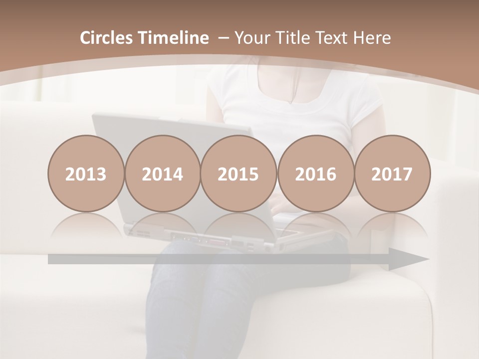 A Woman Sitting On A Couch Using A Laptop Computer PowerPoint Template