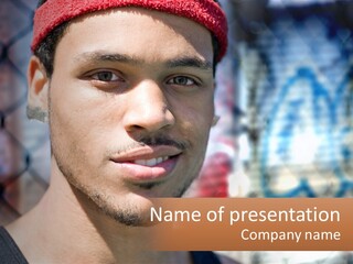A Man In A Red Hat Is Looking At The Camera PowerPoint Template