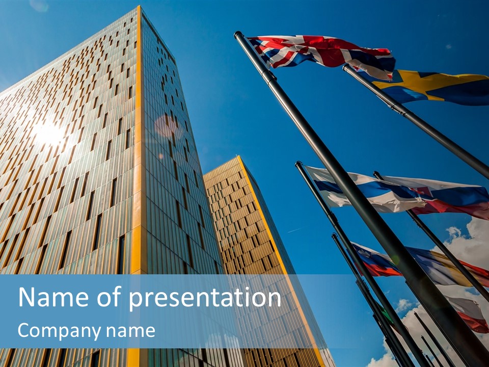 A Group Of Flags Flying In Front Of A Tall Building PowerPoint Template