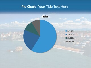 A View Of A Beach With A City In The Background PowerPoint Template