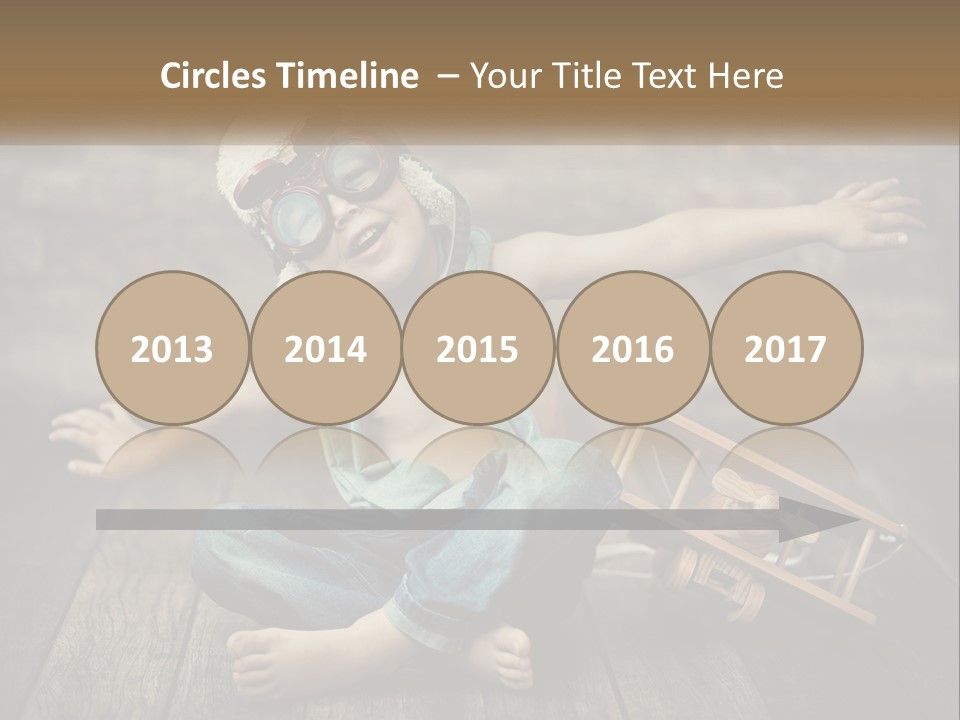 A Young Boy In A Hat And Scarf Sitting On A Wooden Floor PowerPoint Template