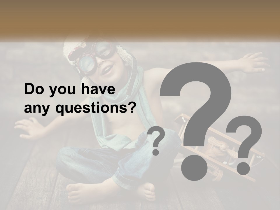 A Young Boy In A Hat And Scarf Sitting On A Wooden Floor PowerPoint Template
