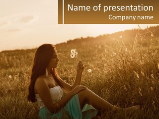 A Woman Sitting In A Field Blowing A Dandelion PowerPoint Template