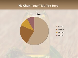 A Bottle Of Oil With A Green Leaf On A Wooden Table PowerPoint Template