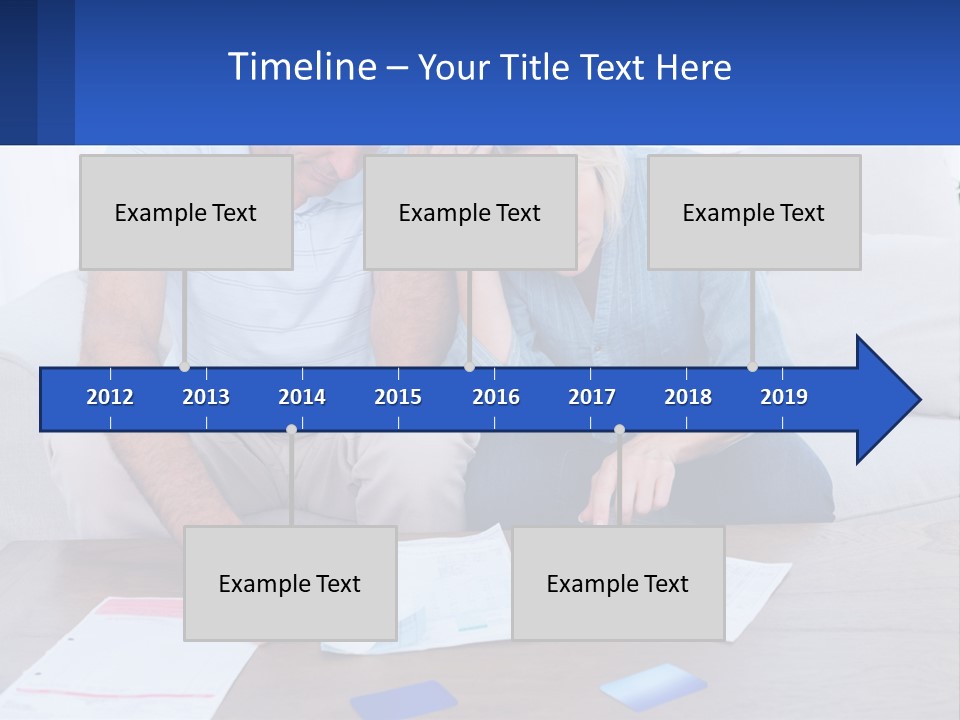 A Man And Woman Sitting On A Couch Looking At A Calculator PowerPoint Template