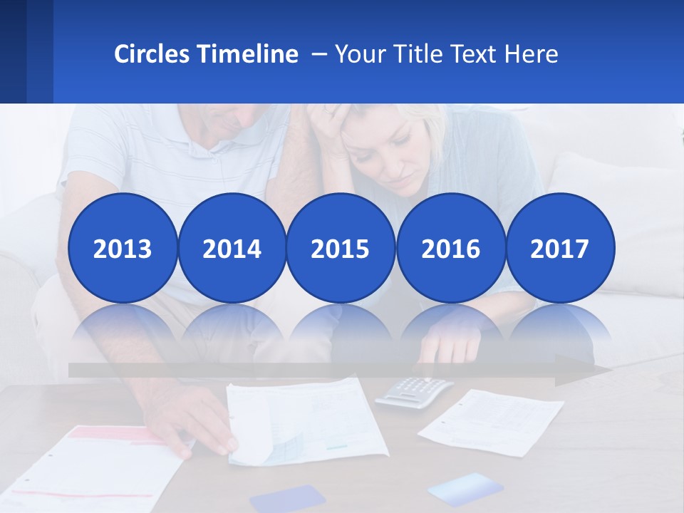 A Man And Woman Sitting On A Couch Looking At A Calculator PowerPoint Template