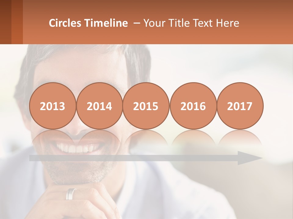 A Man Smiling With A Business Card In Front Of Him PowerPoint Template