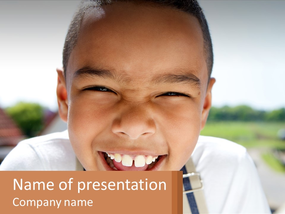 A Young Boy Smiling With His Mouth Open PowerPoint Template