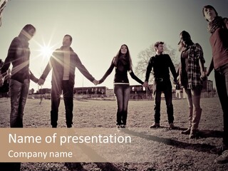 A Group Of People Holding Hands In A Field PowerPoint Template