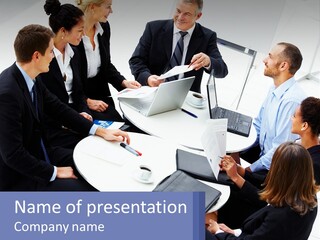A Group Of People Sitting Around A Table With Laptops PowerPoint Template
