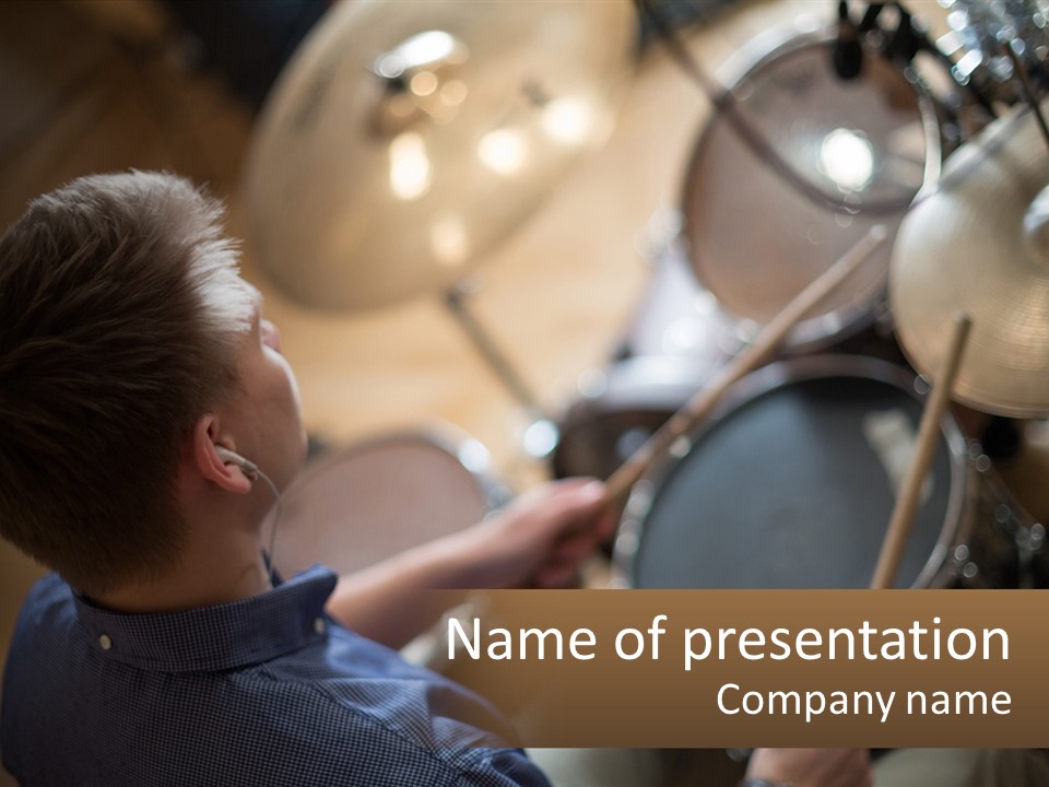 A Young Boy Playing Drums In Front Of A Drum Set PowerPoint Template