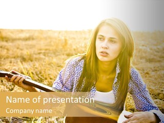 A Woman Sitting In A Field Holding A Guitar PowerPoint Template