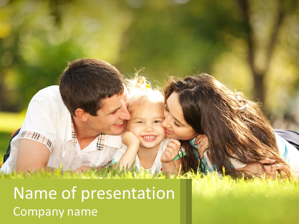 A Family Laying On The Grass In A Park PowerPoint Template