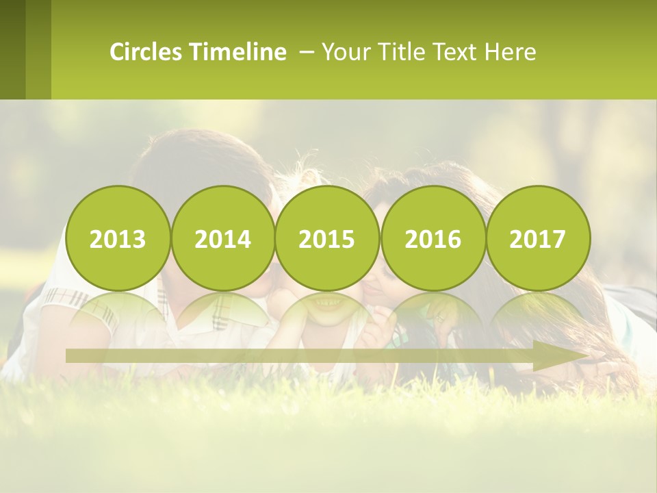 A Family Laying On The Grass In A Park PowerPoint Template