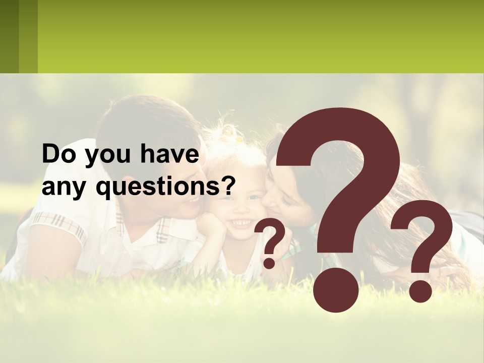 A Family Laying On The Grass In A Park PowerPoint Template