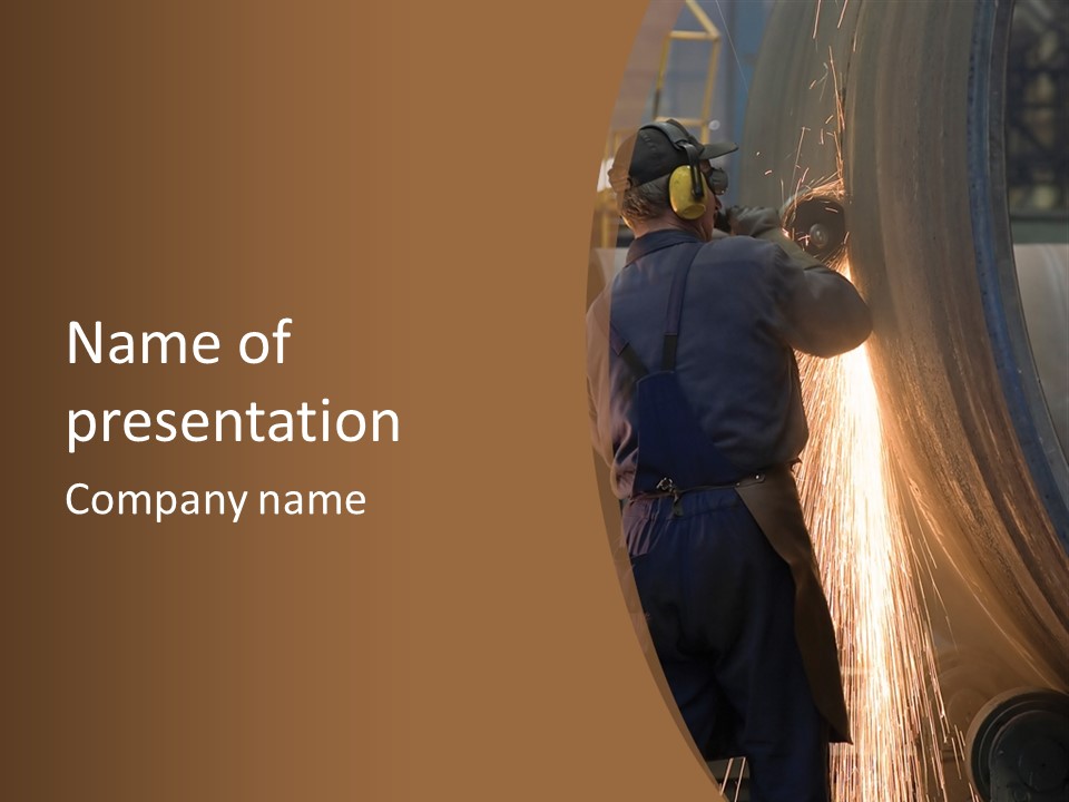 A Man Working On A Piece Of Metal In A Factory PowerPoint Template