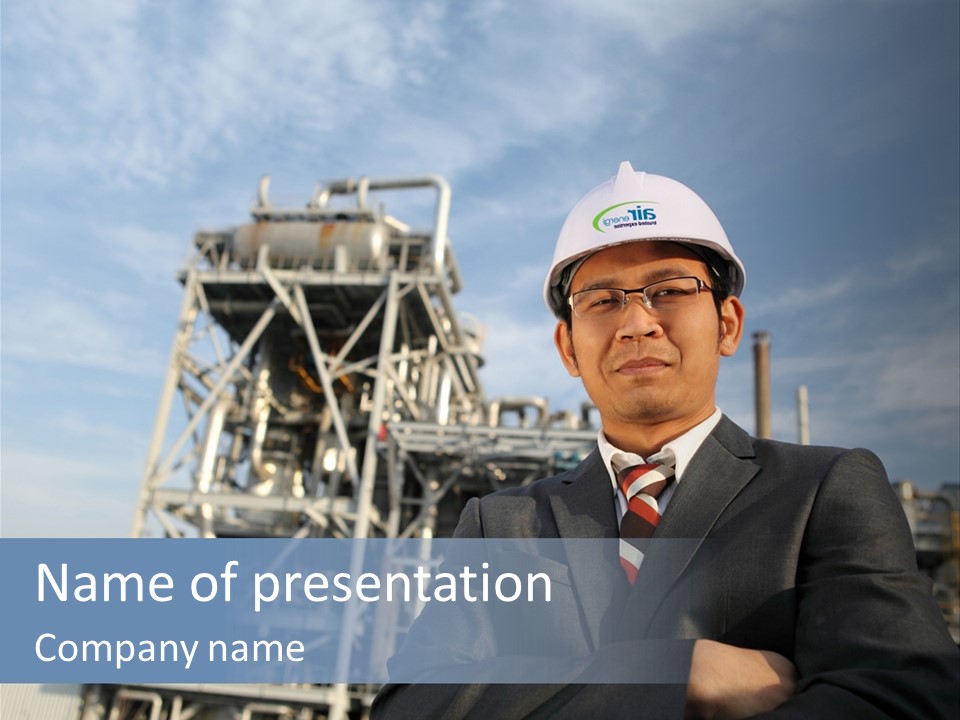 A Man Wearing A Hard Hat Standing In Front Of A Power Plant PowerPoint Template