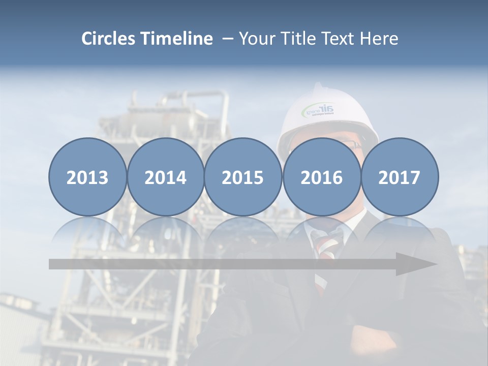 A Man Wearing A Hard Hat Standing In Front Of A Power Plant PowerPoint Template