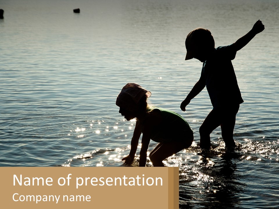 Two Children Playing In A Body Of Water PowerPoint Template