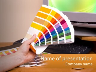 A Person Holding A Color Swater Over A Computer Screen PowerPoint Template