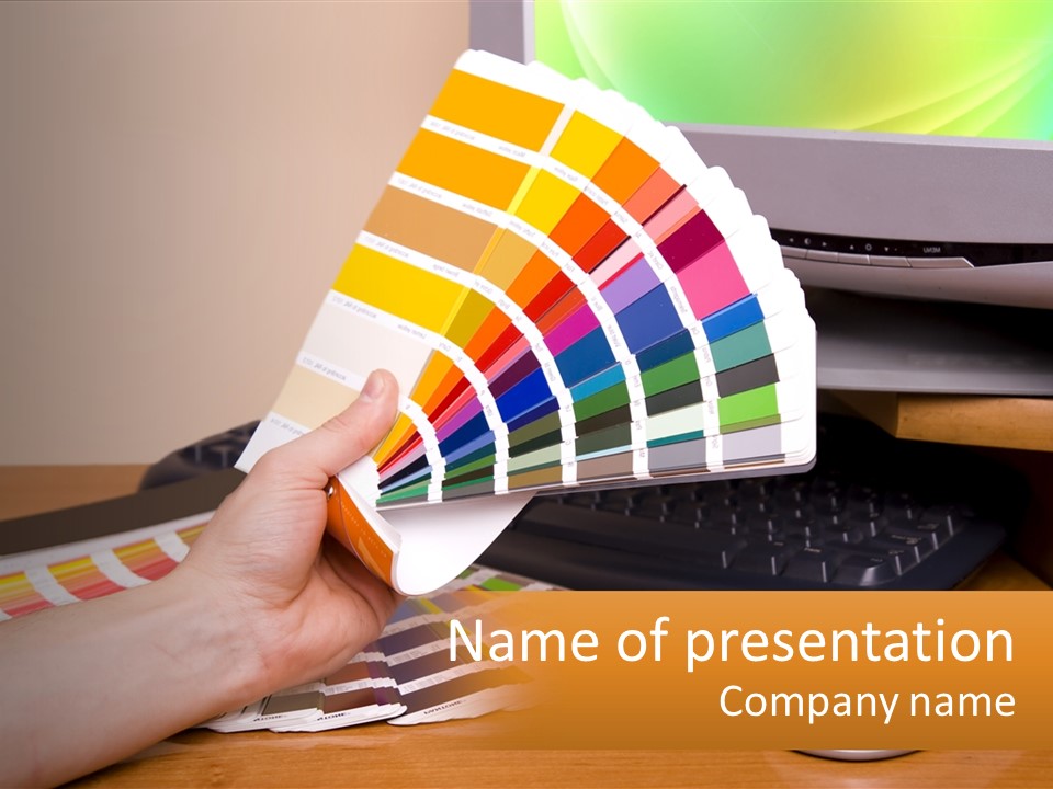 A Person Holding A Color Swater Over A Computer Screen PowerPoint Template