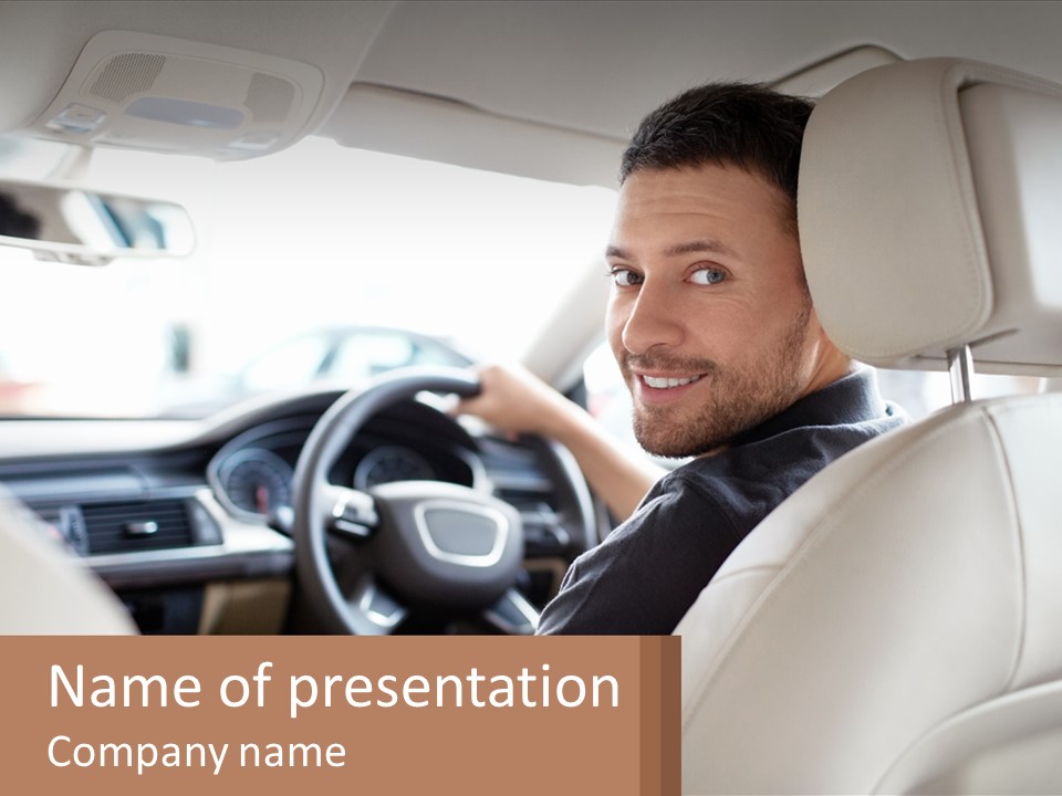 A Man Sitting In A Car With A Steering Wheel PowerPoint Template