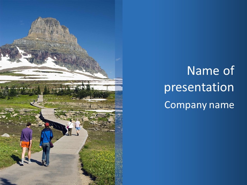 A Group Of People Walking Down A Path Towards A Mountain PowerPoint Template