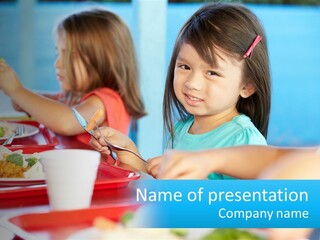 A Group Of Children Sitting At A Table Eating Food PowerPoint Template