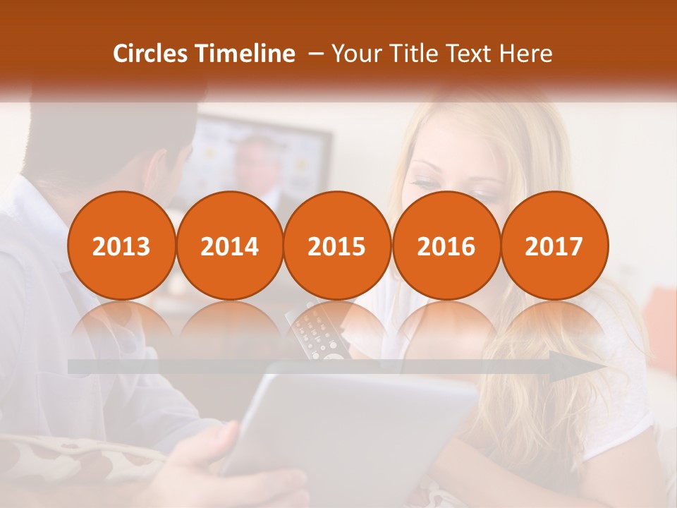 A Man And A Woman Sitting In Front Of A Television PowerPoint Template