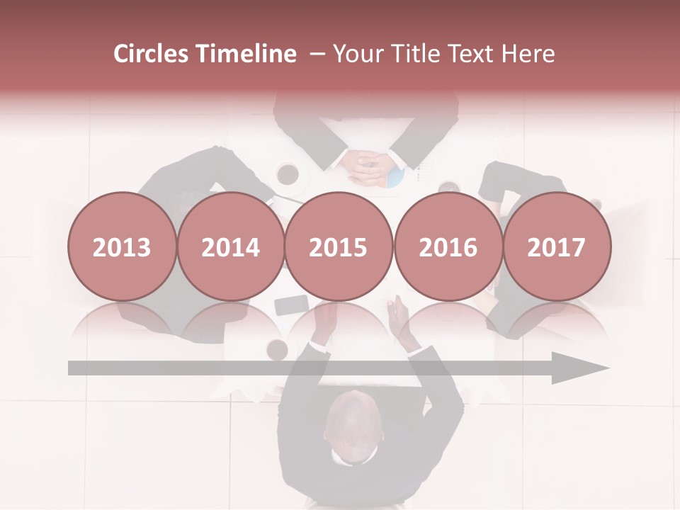 A Group Of People Sitting Around A Table PowerPoint Template